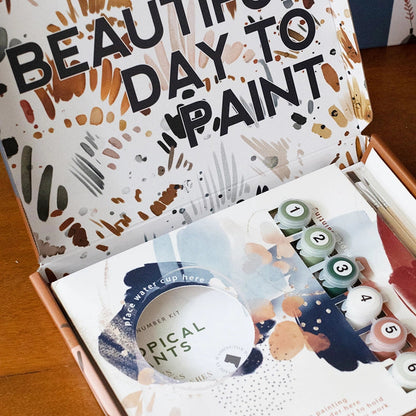 Painting supplies set with a box featuring 'It's a Beautiful Day to Paint' text.